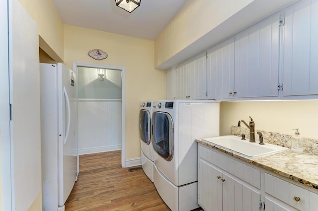 26 Carriage House Ln, Orland Park, IL 60467 - laundry room with washing machine and clothes dryer, light wood finished floors, cabinet space, and wainscoting