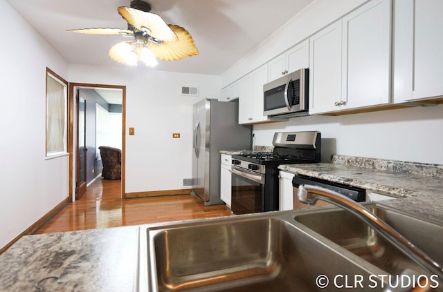 17405 Longfellow Ave, Hazel Crest, IL 60429 - kitchen with appliances with stainless steel finishes, white cabinetry, light wood-style floors, a ceiling fan, and light countertops