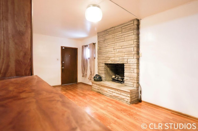 17405 Longfellow Ave, Hazel Crest, IL 60429 - unfurnished living room with a stone fireplace and wood finished floors