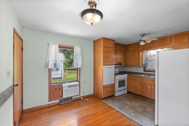 345 W Jeffery St, Kankakee, IL 60901 - kitchen with white appliances, brown cabinetry, ceiling fan, and dark countertops