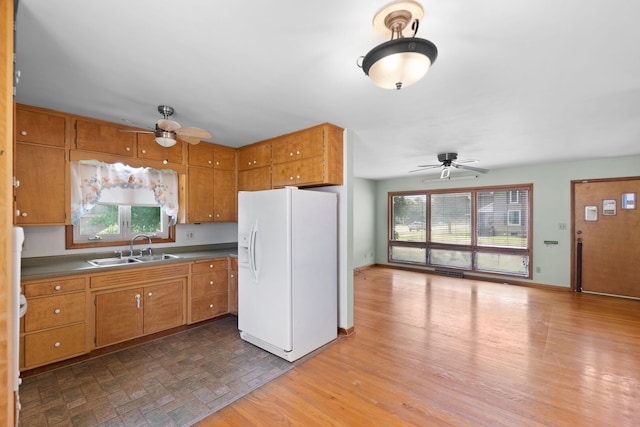 345 W Jeffery St, Kankakee, IL 60901 - kitchen with white refrigerator with ice dispenser, ceiling fan, brown cabinets, and plenty of natural light