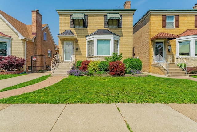 1820 Maple Ave, Berwyn, IL 60402 - view of front of house with a front lawn, brick siding, and a chimney