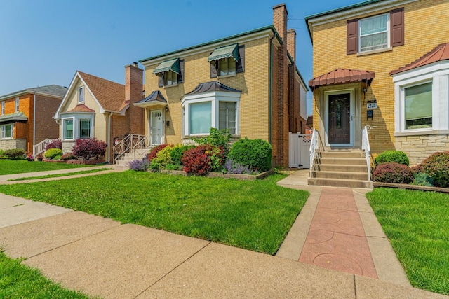 1820 Maple Ave, Berwyn, IL 60402 - view of front facade featuring brick siding, a front yard, and a chimney