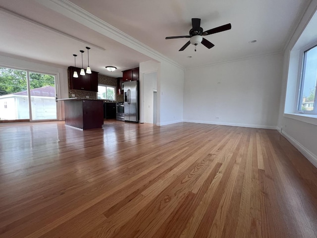 11133 Boeger Ct, Westchester, IL 60154 - unfurnished living room with plenty of natural light, wood finished floors, a ceiling fan, and crown molding