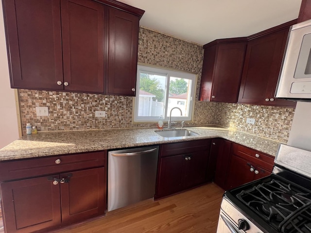 11133 Boeger Ct, Westchester, IL 60154 - kitchen featuring appliances with stainless steel finishes, light wood-type flooring, backsplash, and light stone countertops