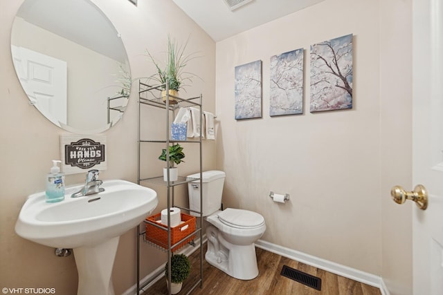 142 W Park Ave Unit C, Sugar Grove, IL 60554 - half bathroom featuring wood finished floors and toilet