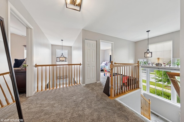 142 W Park Ave Unit C, Sugar Grove, IL 60554 - corridor with an upstairs landing, carpet flooring, and a chandelier