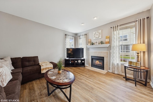 142 W Park Ave Unit C, Sugar Grove, IL 60554 - living room with wood finished floors, healthy amount of natural light, a tile fireplace, and recessed lighting