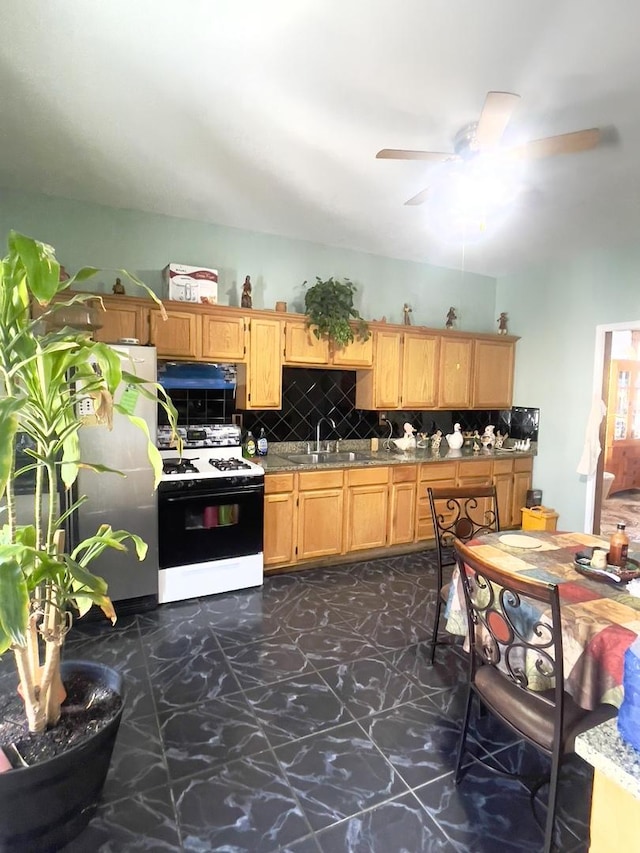 2632 S Austin Blvd, Cicero, IL 60804 - kitchen with white range with gas stovetop, a ceiling fan, tasteful backsplash, and dark flooring