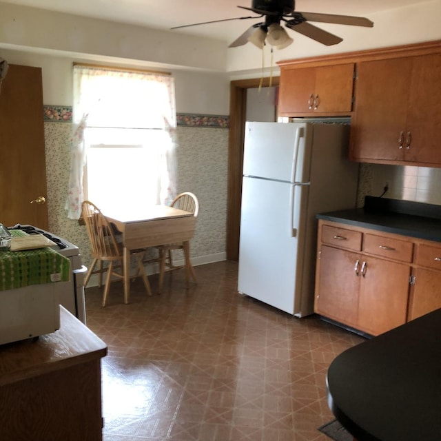 1525 Morgan Ave, La Grange Park, IL 60526 - kitchen featuring freestanding refrigerator, a ceiling fan, wallpapered walls, tile patterned floors, and brown cabinetry