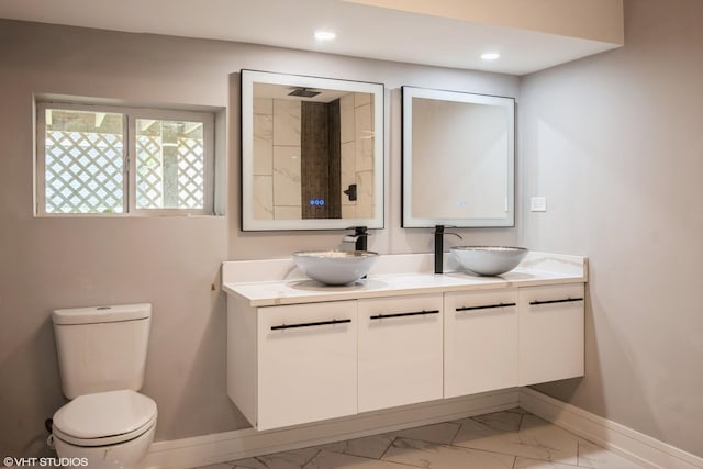 11616 S Lowe Ave, Chicago, IL 60628 - bathroom featuring marble look tile flooring, double vanity, and recessed lighting