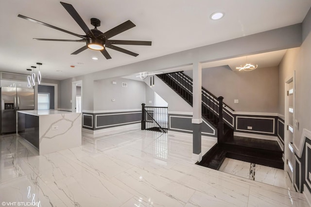 11616 S Lowe Ave, Chicago, IL 60628 - living area featuring wainscoting, recessed lighting, a ceiling fan, stairway, and a decorative wall