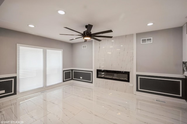 11616 S Lowe Ave, Chicago, IL 60628 - unfurnished living room featuring marble finish flooring, recessed lighting, ceiling fan, a decorative wall, and wainscoting
