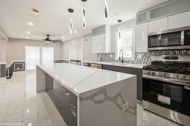 11616 S Lowe Ave, Chicago, IL 60628 - kitchen with stainless steel appliances, pendant lighting, tasteful backsplash, a center island, and recessed lighting