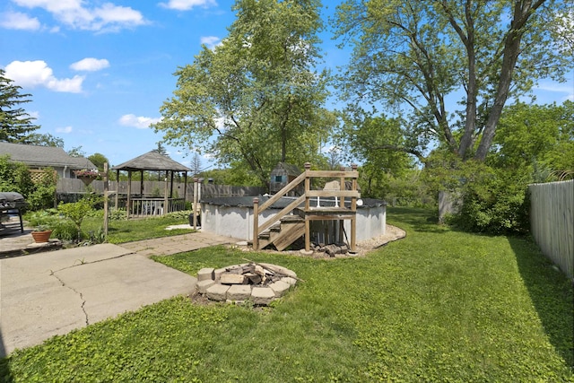 277 Mcmillan St, Grayslake, IL 60030 - fenced backyard with a gazebo, a fire pit, and stairway