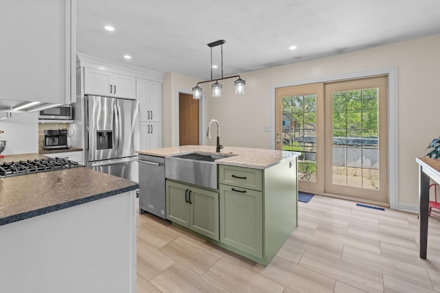 277 Mcmillan St, Grayslake, IL 60030 - kitchen with green cabinets, appliances with stainless steel finishes, white cabinetry, recessed lighting, and an island with sink