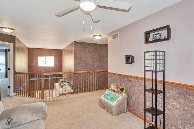 1612 Whisper Glen Dr, Plainfield, IL 60586 - living area featuring carpet flooring, ceiling fan, healthy amount of natural light, an upstairs landing, and a wainscoted wall