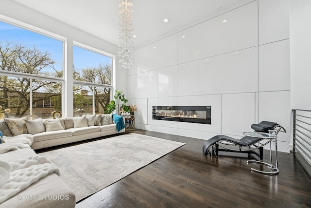 2503 N Maplewood Ave, Chicago, IL 60647 - living area with wood finished floors, a glass covered fireplace, recessed lighting, and a high ceiling