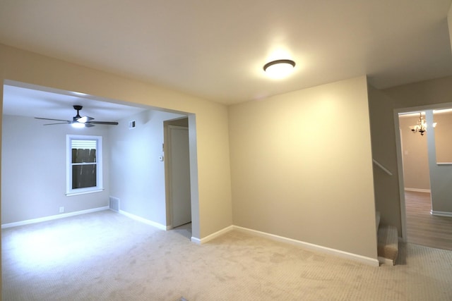 123 E Pineview Dr, Round Lake Park, IL 60073 - unfurnished room with light colored carpet, a ceiling fan, and a chandelier