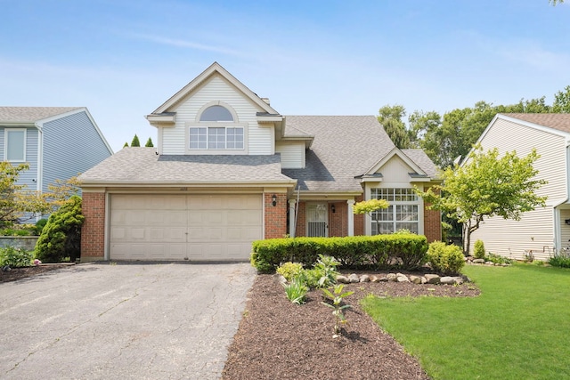 1678 Penny Ln, Bartlett, IL 60103 - traditional-style home featuring brick siding, asphalt driveway, a shingled roof, a front yard, and a garage
