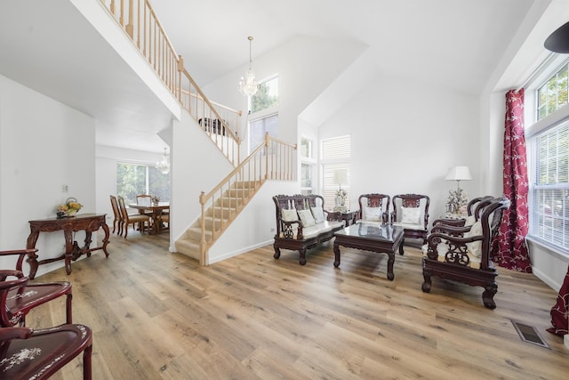 1678 Penny Ln, Bartlett, IL 60103 - living area with a chandelier, stairway, high vaulted ceiling, plenty of natural light, and wood finished floors