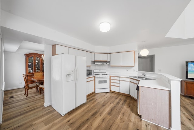 1678 Penny Ln, Bartlett, IL 60103 - kitchen featuring white appliances, a peninsula, under cabinet range hood, light countertops, and light wood-type flooring