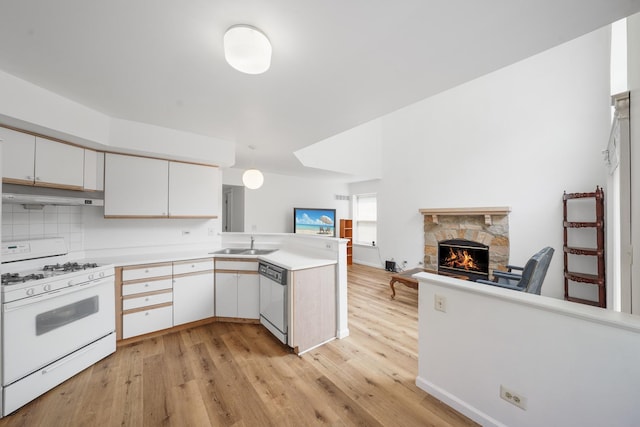 1678 Penny Ln, Bartlett, IL 60103 - kitchen with white appliances, ventilation hood, open floor plan, a peninsula, and a stone fireplace