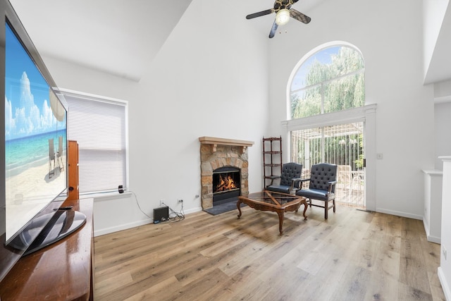 1678 Penny Ln, Bartlett, IL 60103 - living area featuring high vaulted ceiling, a fireplace, wood finished floors, and a ceiling fan