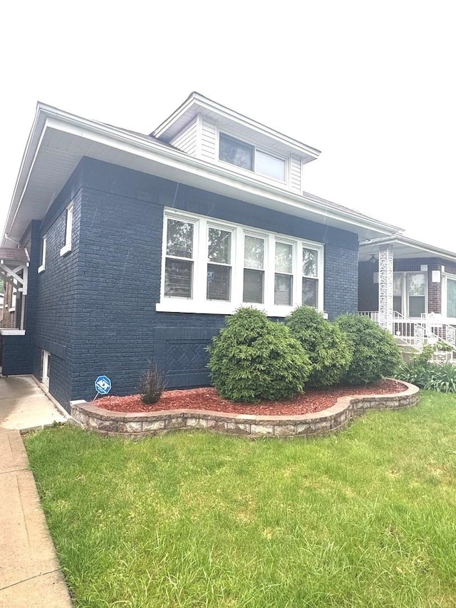 9432 S Vernon Ave, Chicago, IL 60619 - view of home's exterior with brick siding and a lawn