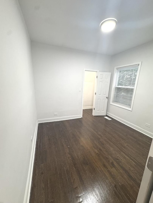 9432 S Vernon Ave, Chicago, IL 60619 - spare room with dark wood-style floors and baseboards