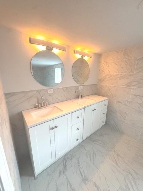 9432 S Vernon Ave, Chicago, IL 60619 - bathroom with tile walls, double vanity, and marble look tile flooring