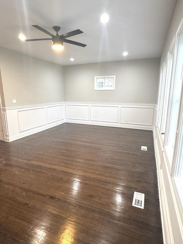 9432 S Vernon Ave, Chicago, IL 60619 - empty room featuring a ceiling fan, dark wood finished floors, a decorative wall, a wainscoted wall, and recessed lighting