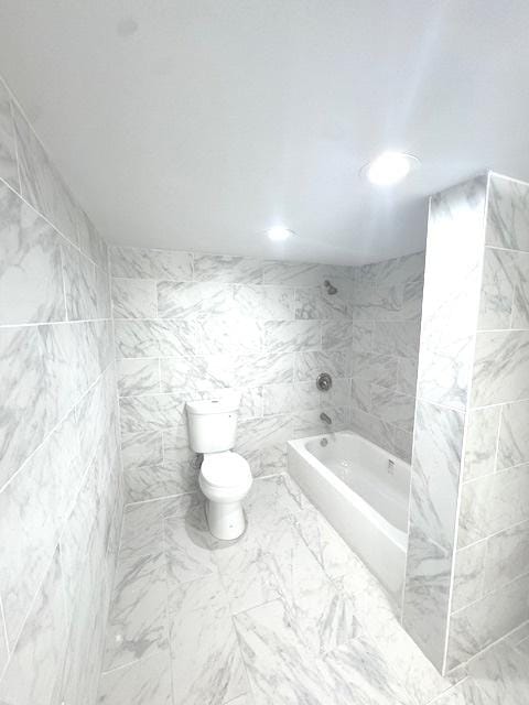 9432 S Vernon Ave, Chicago, IL 60619 - bathroom with marble look tile flooring,  shower combination, recessed lighting, and tile walls