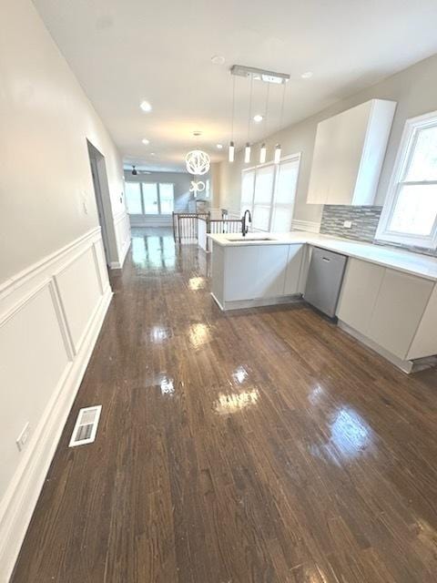 9432 S Vernon Ave, Chicago, IL 60619 - kitchen featuring dishwasher, dark wood finished floors, plenty of natural light, a peninsula, and wainscoting