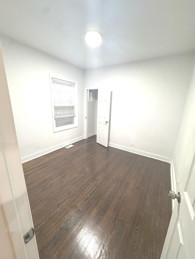 9432 S Vernon Ave, Chicago, IL 60619 - empty room featuring dark wood finished floors and baseboards
