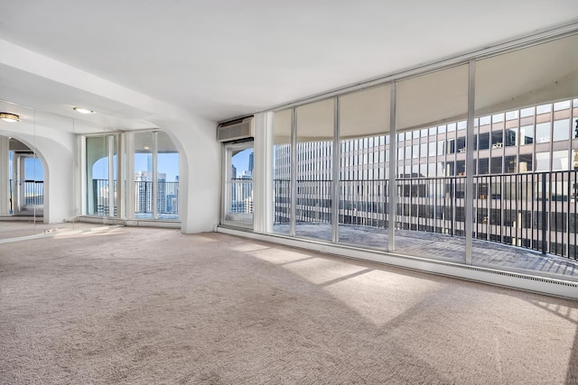 300 N State St Unit 5320, Chicago, IL 60654 - unfurnished living room featuring carpet floors, a wall mounted air conditioner, plenty of natural light, and arched walkways