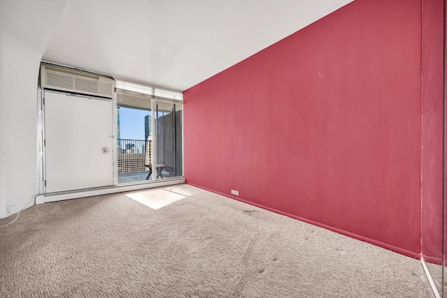 300 N State St Unit 5320, Chicago, IL 60654 - unfurnished room with a baseboard heating unit, carpet, a wall of windows, and an AC wall unit
