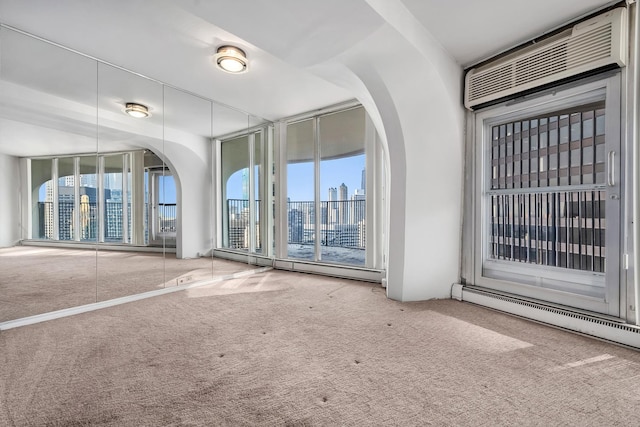 300 N State St Unit 5320, Chicago, IL 60654 - carpeted spare room with a baseboard heating unit, arched walkways, and a baseboard radiator