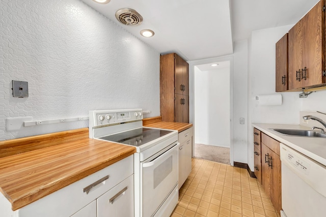 300 N State St Unit 5320, Chicago, IL 60654 - kitchen with white appliances, wooden counters, brown cabinets, and recessed lighting