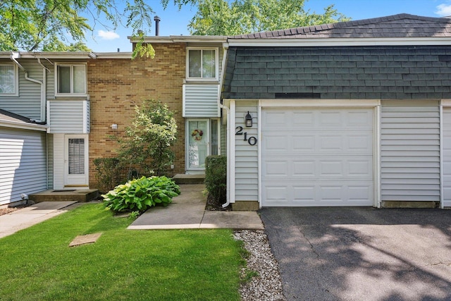 210 Diane Ln, Bolingbrook, IL 60440 - view of front of home with roof with shingles, a garage, a front yard, and brick siding