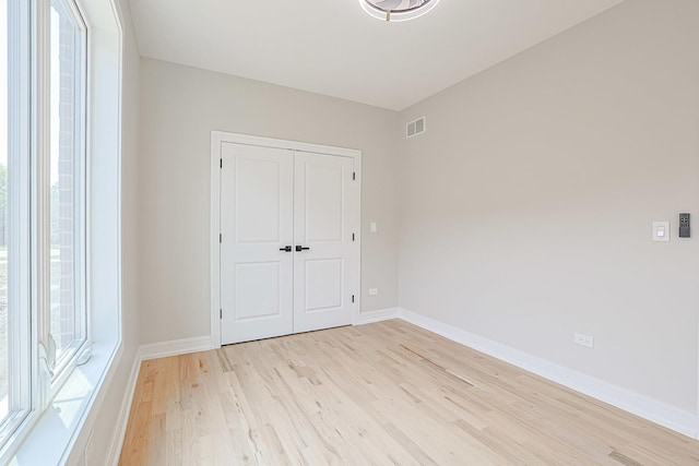 7948 W 74th Ave, Bridgeview, IL 60455 - unfurnished bedroom featuring light wood-type flooring and a closet