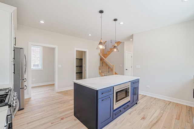 7948 W 74th Ave, Bridgeview, IL 60455 - kitchen with stainless steel appliances, blue cabinets, light wood-style floors, decorative light fixtures, and a kitchen island