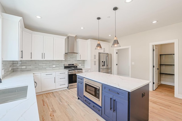 7948 W 74th Ave, Bridgeview, IL 60455 - kitchen with appliances with stainless steel finishes, wall chimney exhaust hood, blue cabinets, white cabinets, and recessed lighting