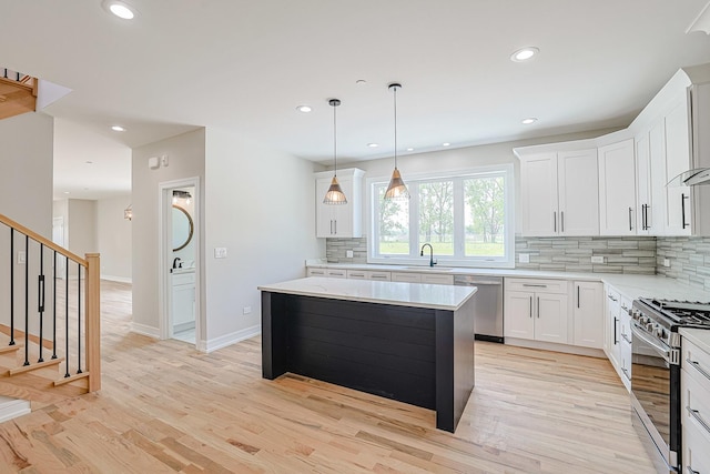 7948 W 74th Ave, Bridgeview, IL 60455 - kitchen with appliances with stainless steel finishes, tasteful backsplash, light wood-style flooring, recessed lighting, and light countertops