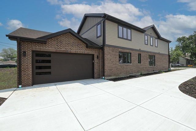 7948 W 74th Ave, Bridgeview, IL 60455 - view of front of home featuring board and batten siding, brick siding, driveway, and an attached garage