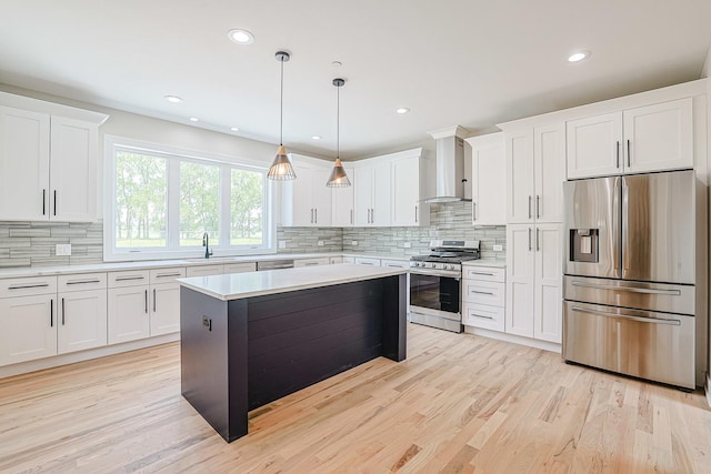 7948 W 74th Ave, Bridgeview, IL 60455 - kitchen featuring appliances with stainless steel finishes, wall chimney range hood, light countertops, tasteful backsplash, and recessed lighting