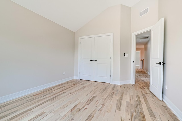 7948 W 74th Ave, Bridgeview, IL 60455 - unfurnished bedroom featuring high vaulted ceiling, light wood finished floors, and a closet