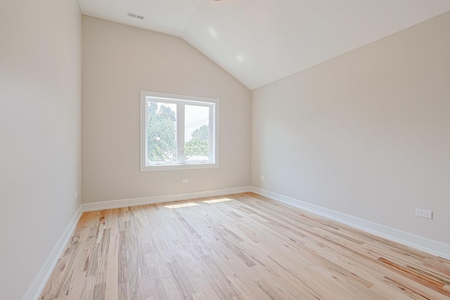 7948 W 74th Ave, Bridgeview, IL 60455 - empty room featuring light wood-style floors and vaulted ceiling