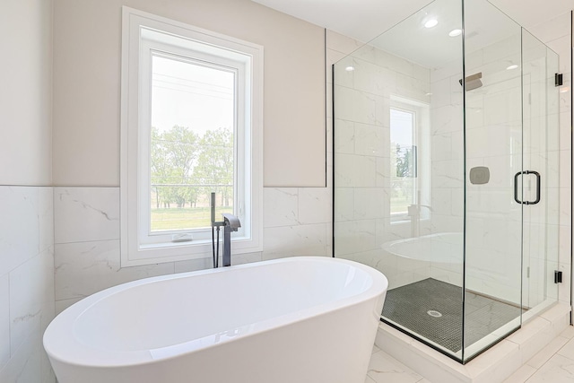 7948 W 74th Ave, Bridgeview, IL 60455 - bathroom featuring tile walls, marble finish flooring, a stall shower, and a soaking tub