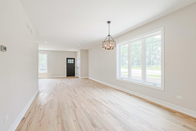 7948 W 74th Ave, Bridgeview, IL 60455 - unfurnished room with light wood-style floors, a chandelier, and recessed lighting